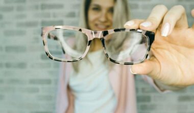 Woman holding eyeglasses